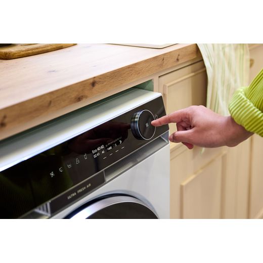 Haier HW110-BD14397U1 11kg Washing Machine with 1400 rpm - White - Person using washing machine control panel shot